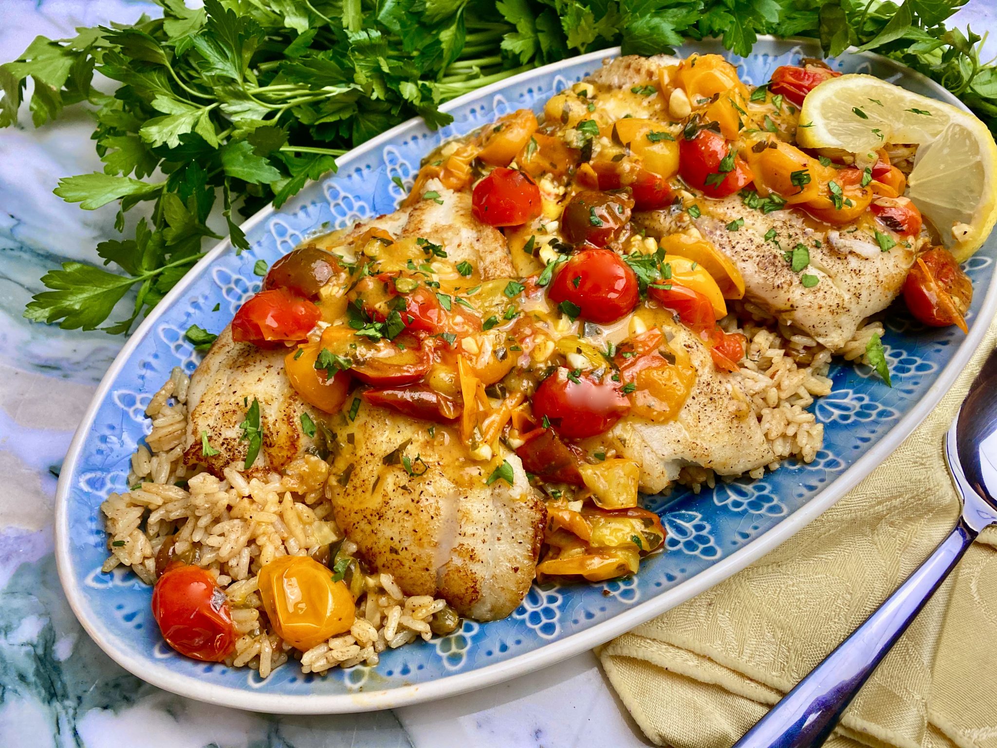 SAUTEED FLOUNDER OVER GOLDEN RAISIN PILAF WITH TOMATO LEMON WINE SAUCE