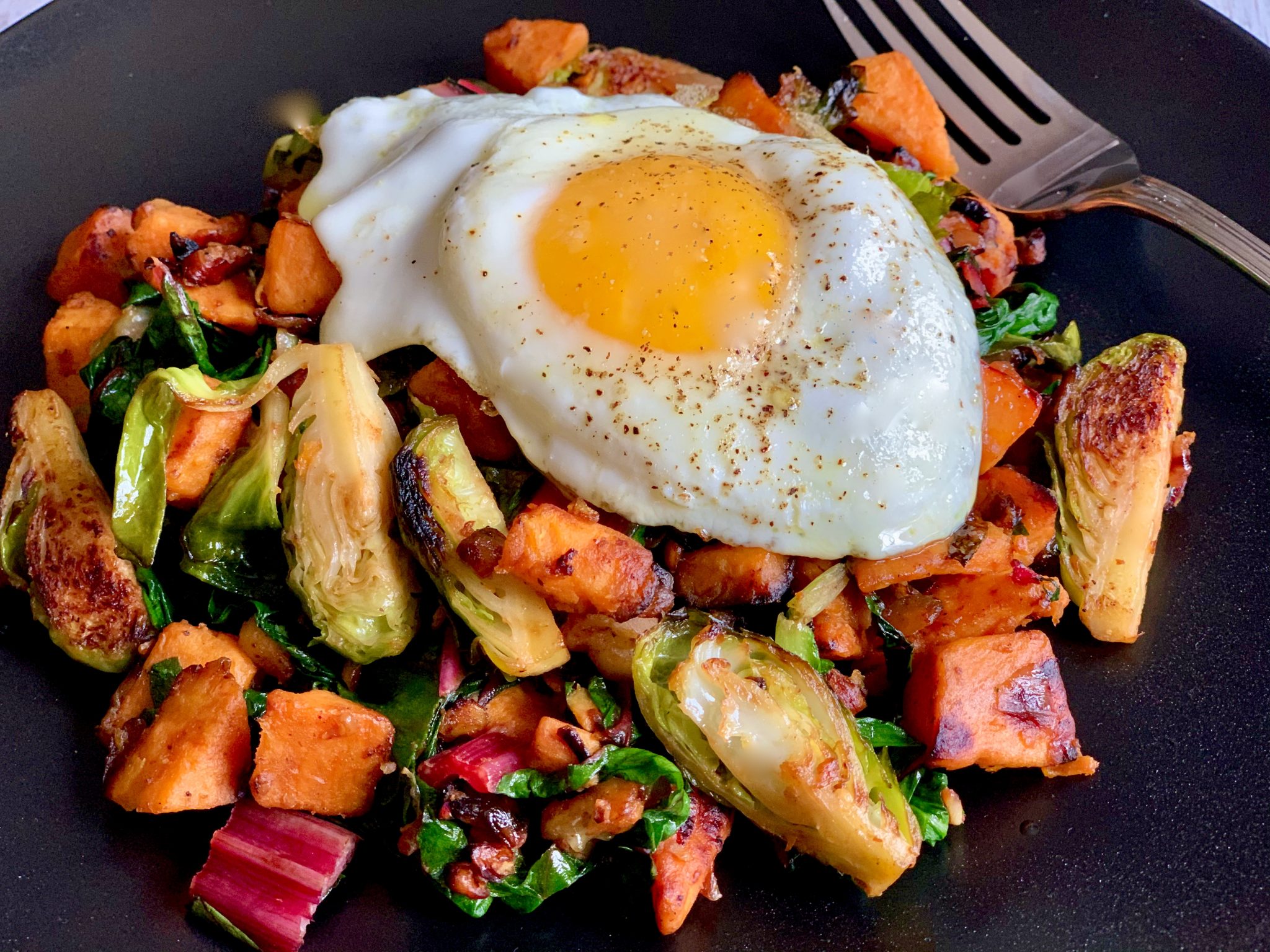 SWEET POTATO AND BRUSSEL SPROUT HASH WITH SUNNY SIDE EGGS Dish off
