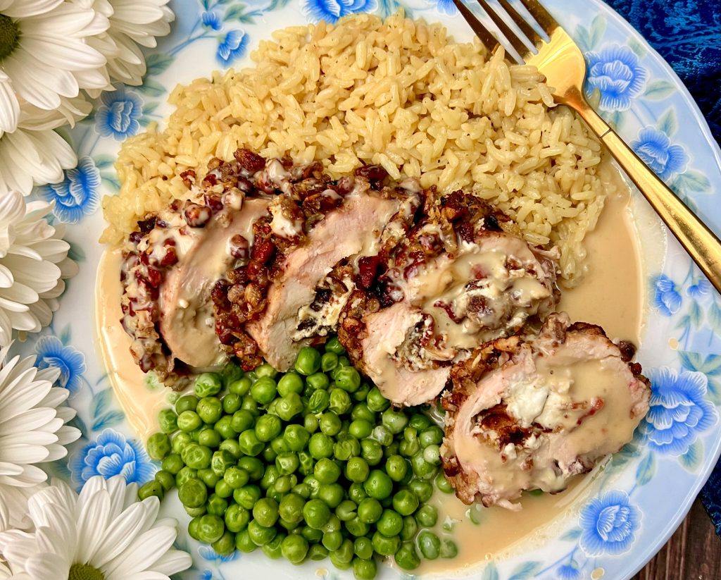 Pecan-Crusted Chicken Stuffed With Bacon, Dates, And Goat Cheese And Topped With A Maple Dijon Cream Sauce