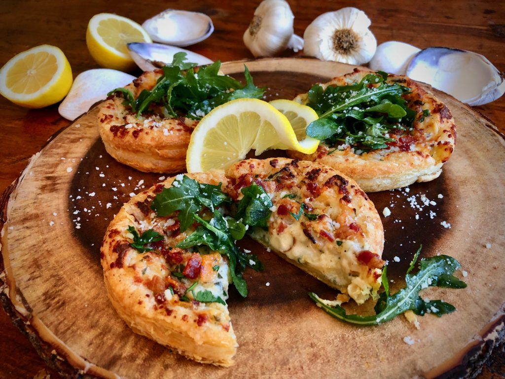 Garlicky Clam Clouds Topped With Bacon And Arugula Salad