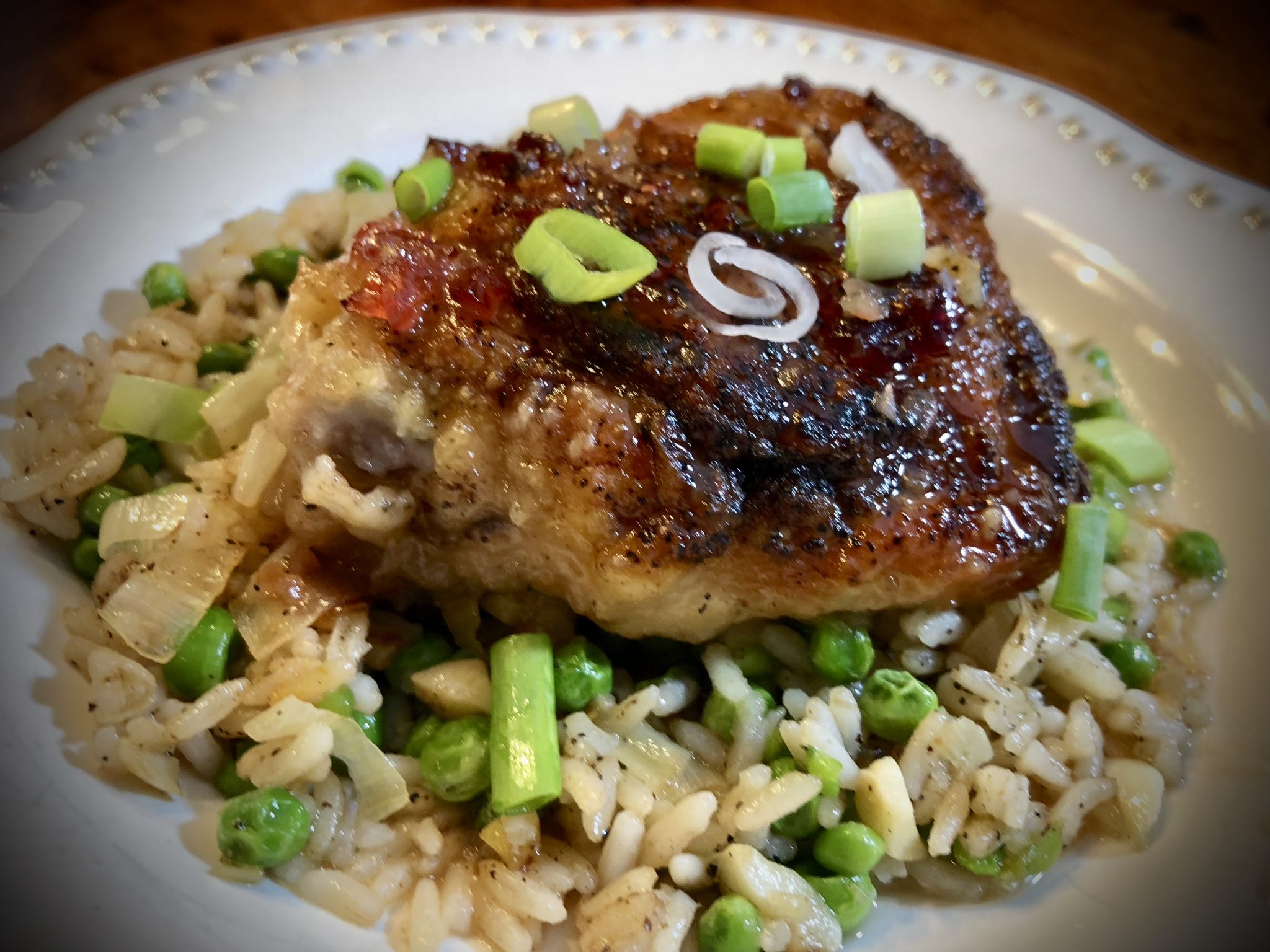 CRANBERRY HORSERADISH GLAZED CHICKEN THIGHS OVER LEEK AND PEA RICE