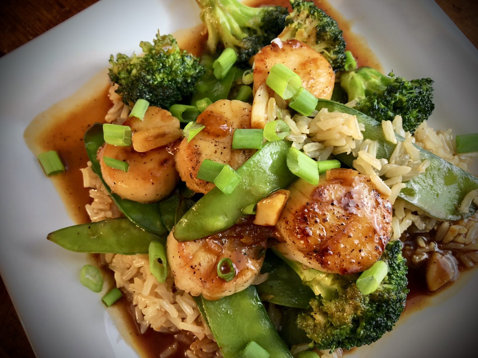 PAN SEARED SCALLOP STIR FRY WITH BROCCOLI AND SNOW PEAS OVER BROWN