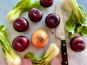 SWEET AND SPICY KOREAN CHICKEN THIGHS WITH PLUMS, ONIONS, AND BOK CHOY