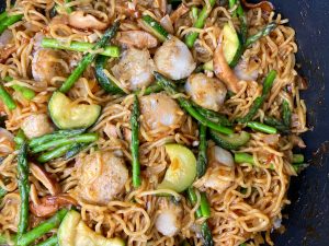SCALLOP AND SPRING VEGETABLE NOODLE STIR FRY WITH SUNNY SIDE TOPPER