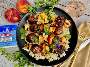 GLAZED LAMB MEATBALL, PANEER, PEACH, AND ZUCCHINI SKEWERS OVER COUSCOUS