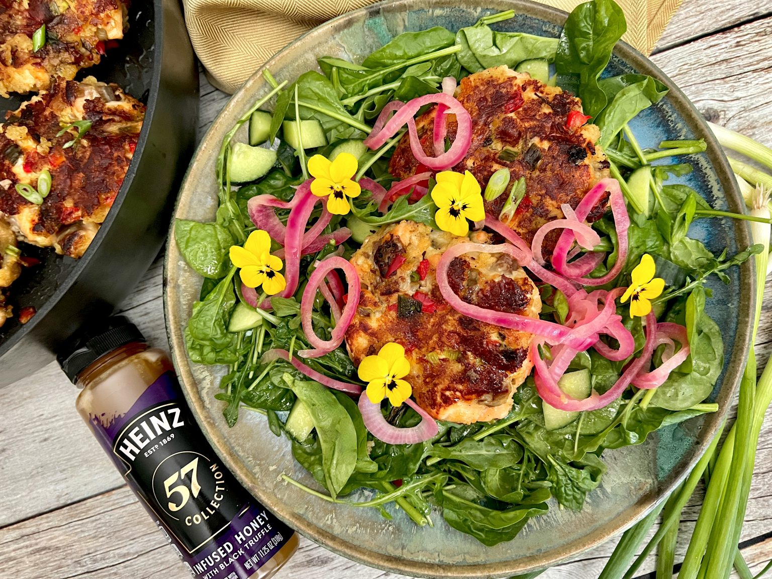 INFUSED TRUFFLE HONEY SALMON CAKE SALAD WITH PICKLED ONIONS AND TRUFFLE