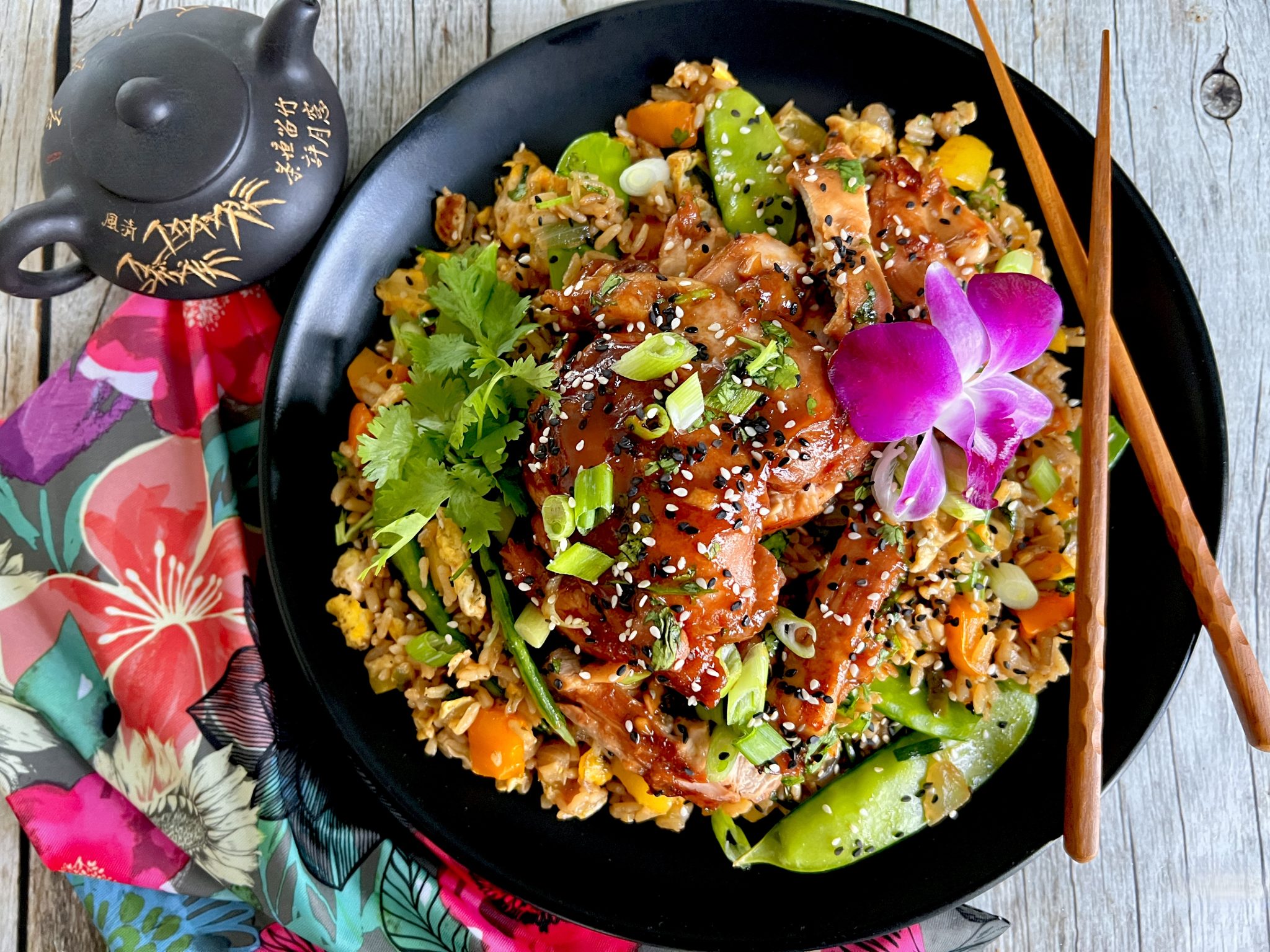 STICKY ASIAN SESAME CHICKEN THIGHS OVER MANGO PEPPER FRIED RICE Dish off the Block